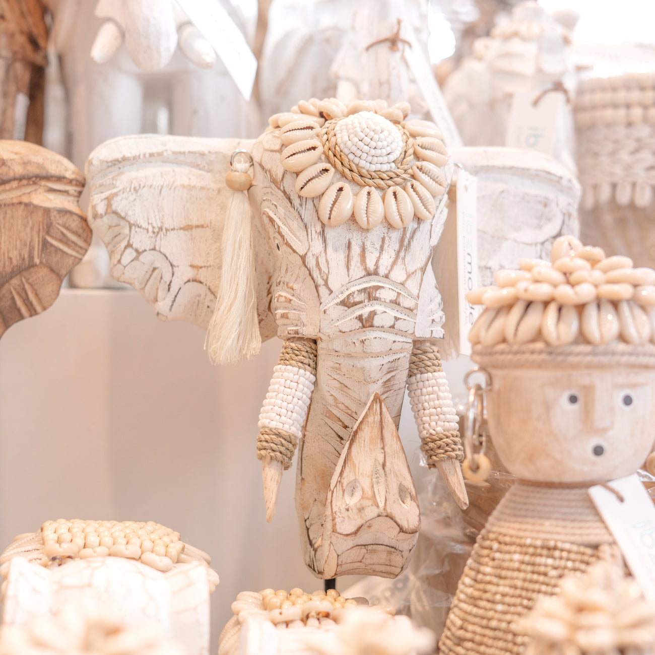 Ibizamode handcrafted white wooden elephant decor with shells and tassels in bohemian interior