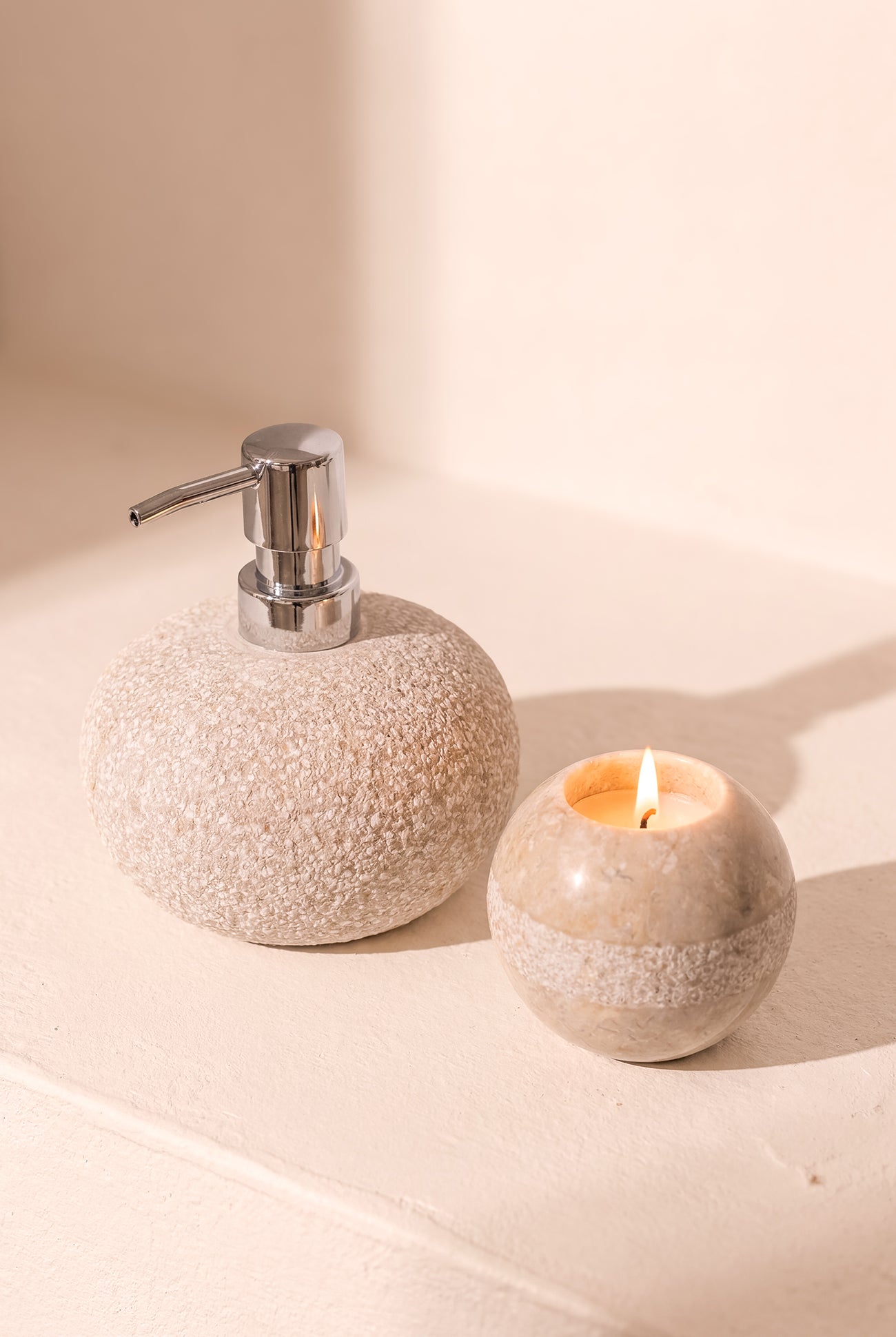 Ibizamode natural stone soap dispenser with textured finish in bohemian bathroom interior
