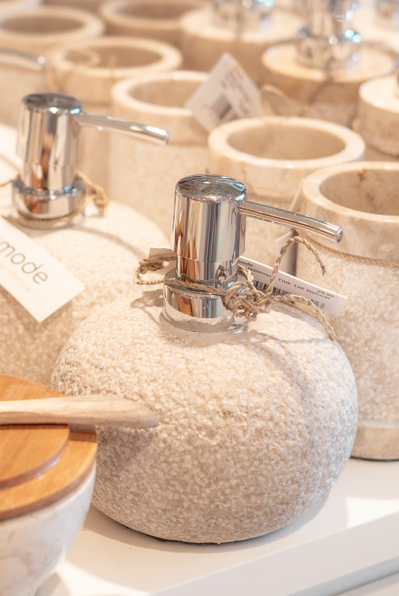 Ibizamode natural stone soap dispenser with textured finish in bohemian bathroom interior