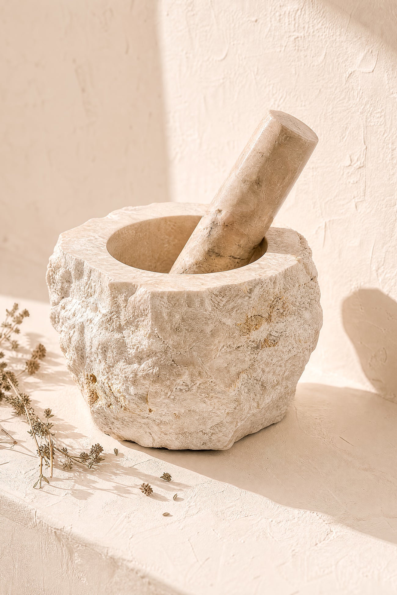 Ibizamode natural marble mortar and pestle with organic stone texture in bohemian interior