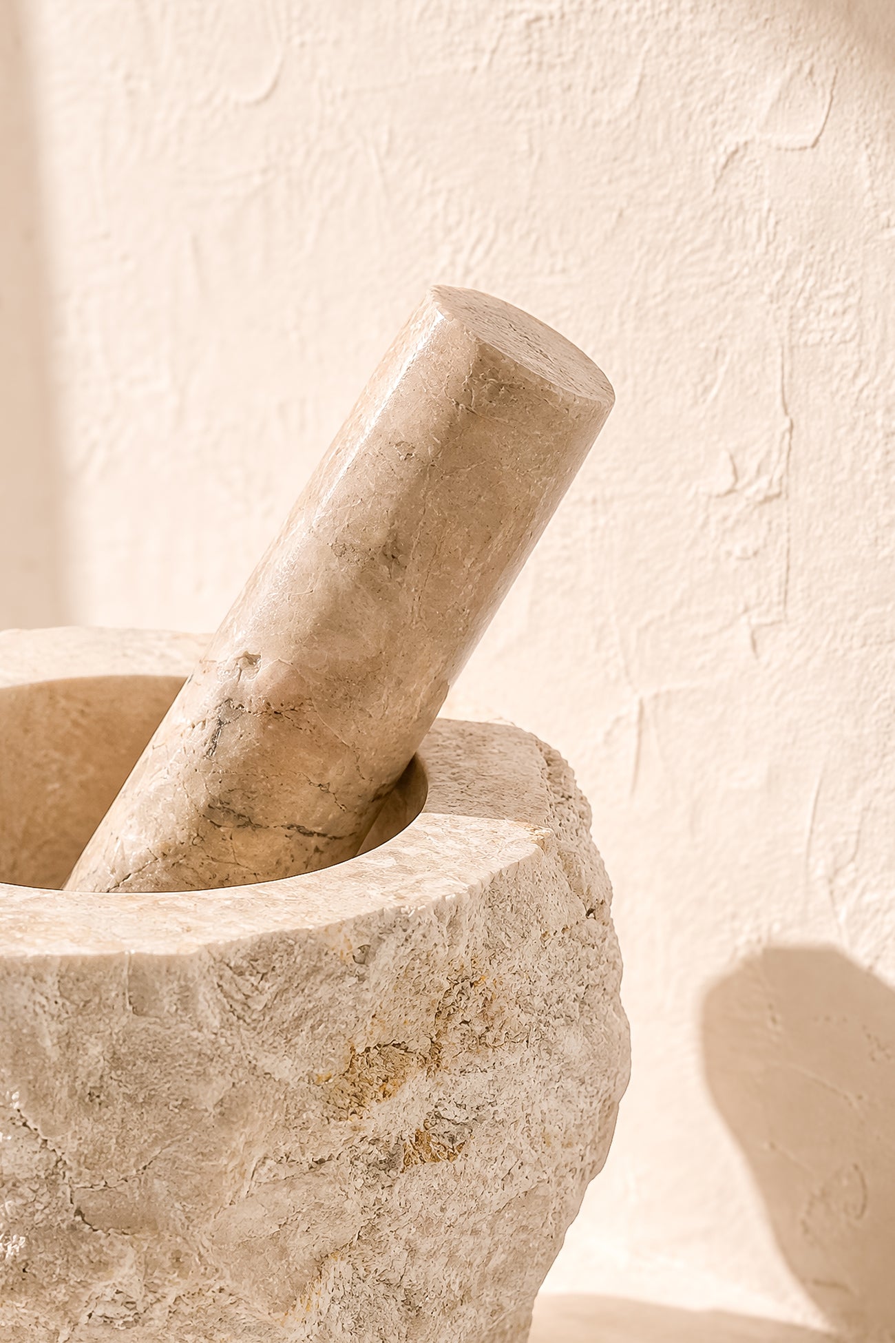 Ibizamode natural marble mortar and pestle with organic stone texture in bohemian interior