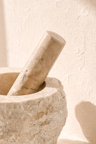 Ibizamode natural marble mortar and pestle with organic stone texture in bohemian interior