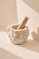 Ibizamode natural marble mortar and pestle with organic stone texture in bohemian interior