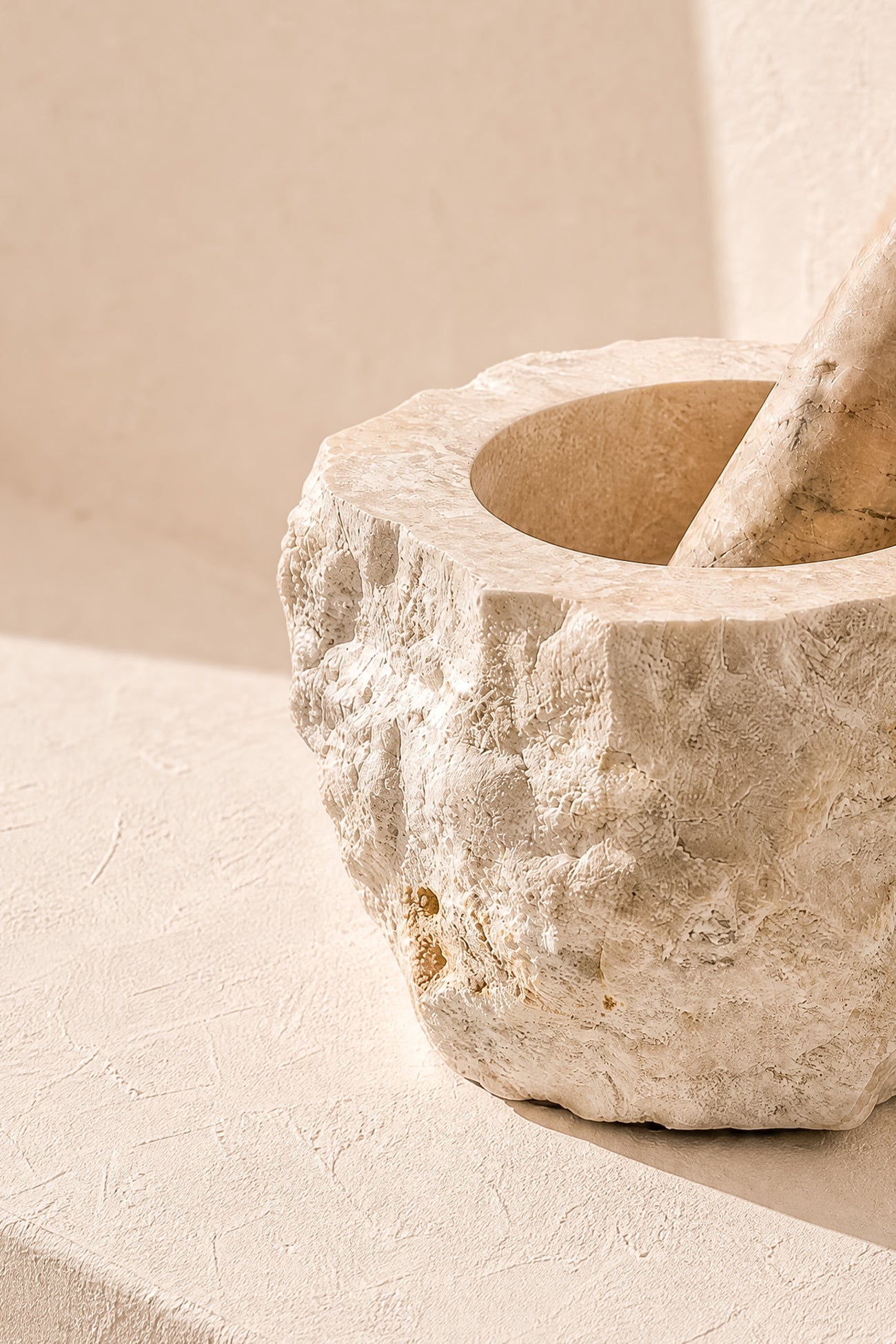 Ibizamode natural marble mortar and pestle with organic stone texture in bohemian interior