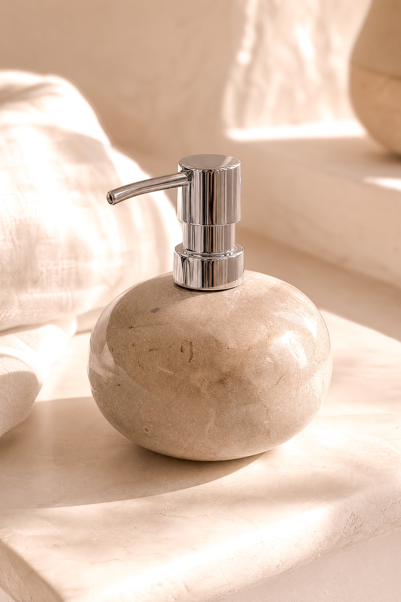 Ibizamode natural stone soap dispenser with silver pump in luxury bohemian bathroom interior