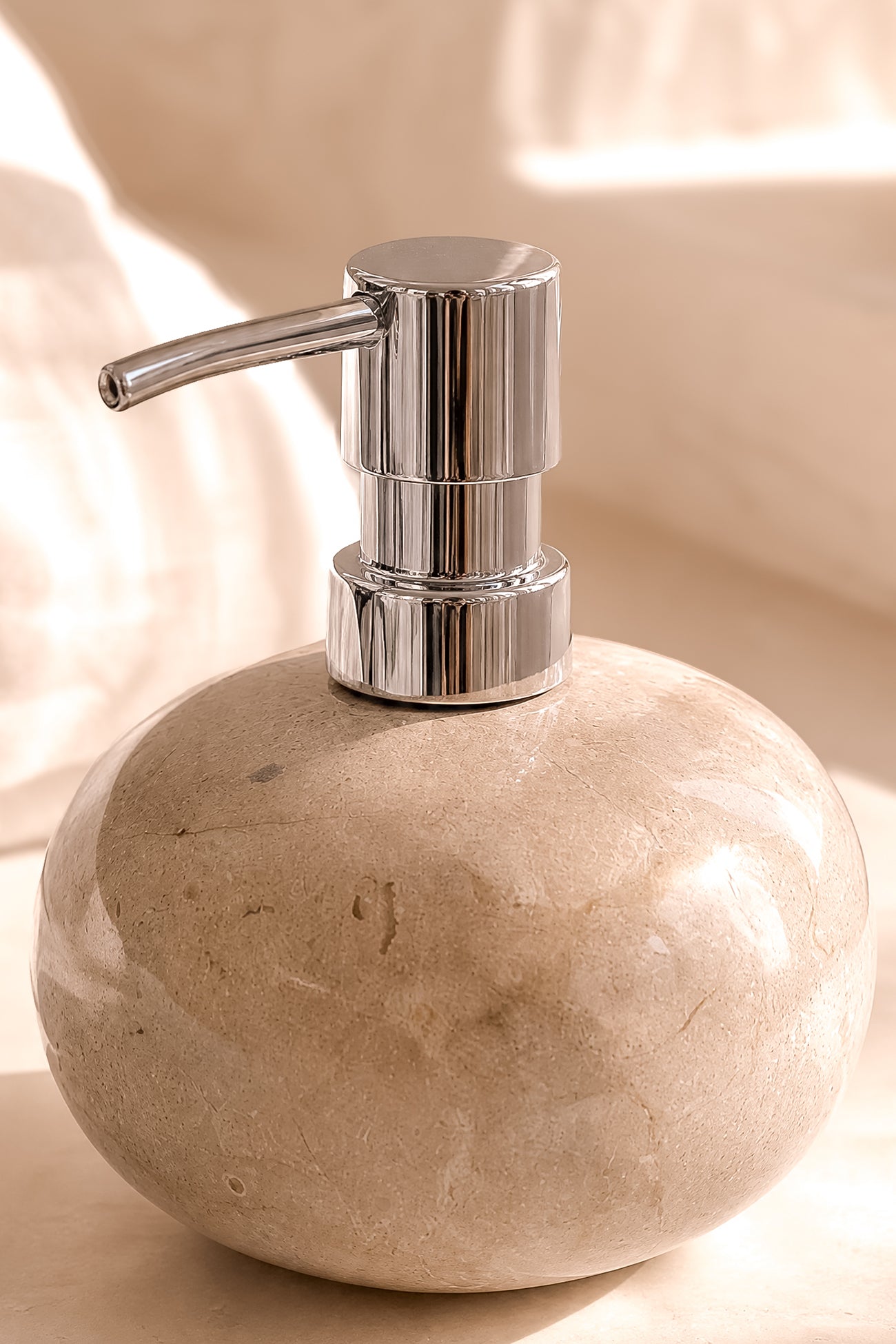 Ibizamode natural stone soap dispenser with silver pump in luxury bohemian bathroom interior