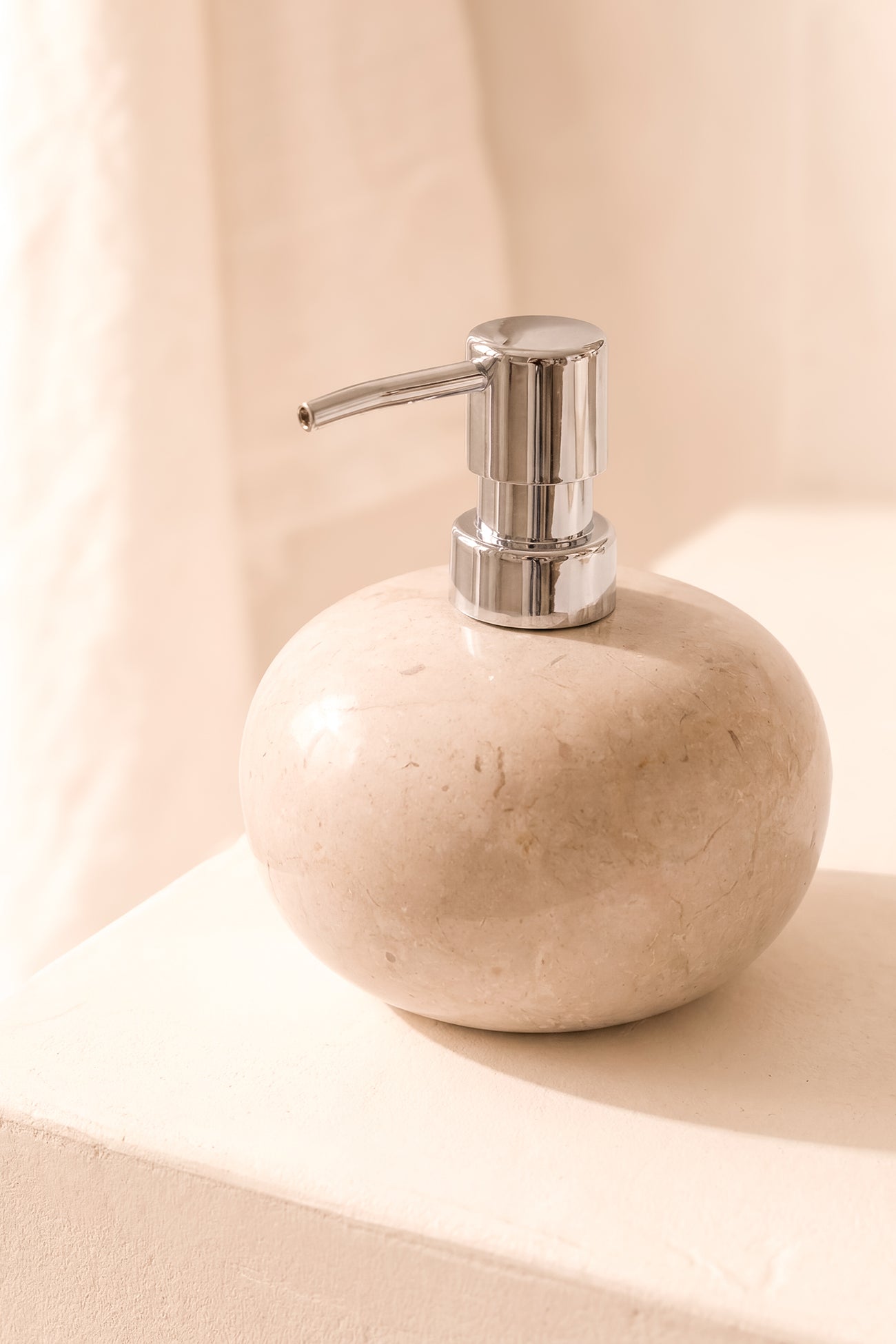 Ibizamode natural stone soap dispenser with silver pump in luxury bohemian bathroom interior