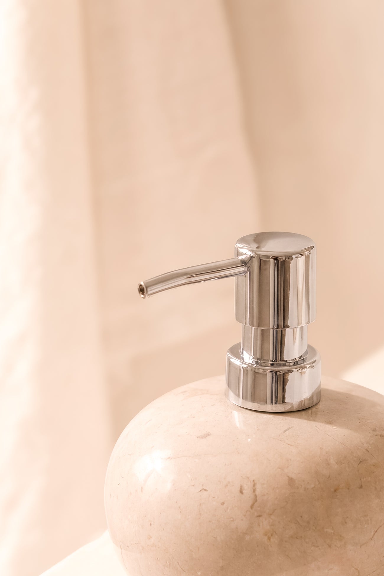 Ibizamode natural stone soap dispenser with silver pump in luxury bohemian bathroom interior