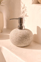Ibizamode natural stone soap dispenser with textured finish in bohemian bathroom interior