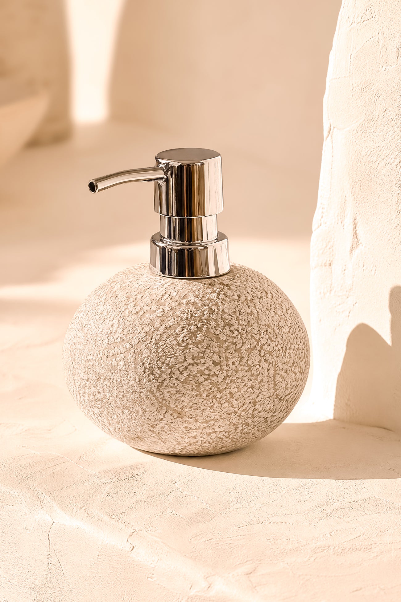 Ibizamode natural stone soap dispenser with textured finish in bohemian bathroom interior