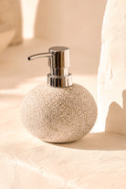 Ibizamode natural stone soap dispenser with textured finish in bohemian bathroom interior