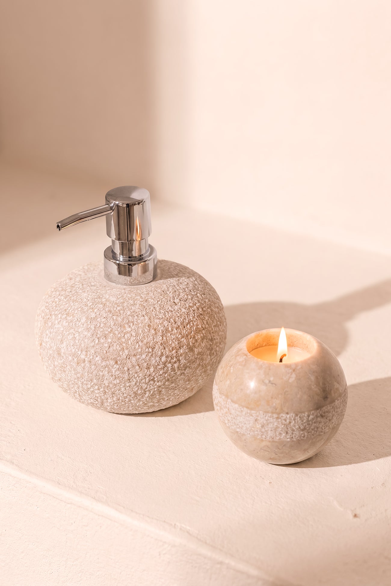 Ibizamode natural stone soap dispenser with textured finish in bohemian bathroom interior