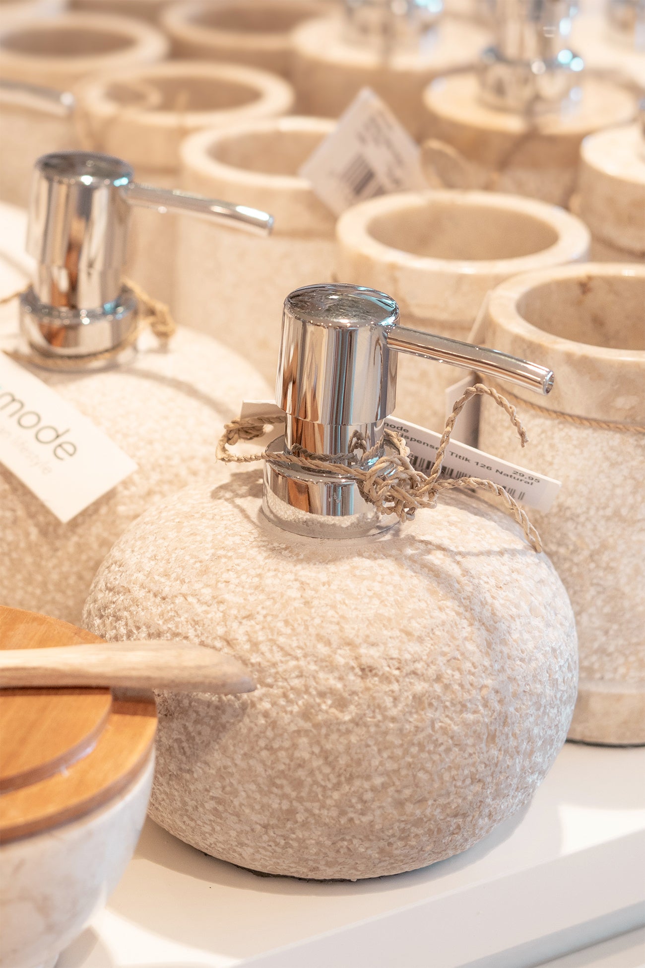 Ibizamode natural stone soap dispenser with textured finish in bohemian bathroom interior